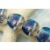 10407112 - Four Transparent Blue Seashell Lentil Beads